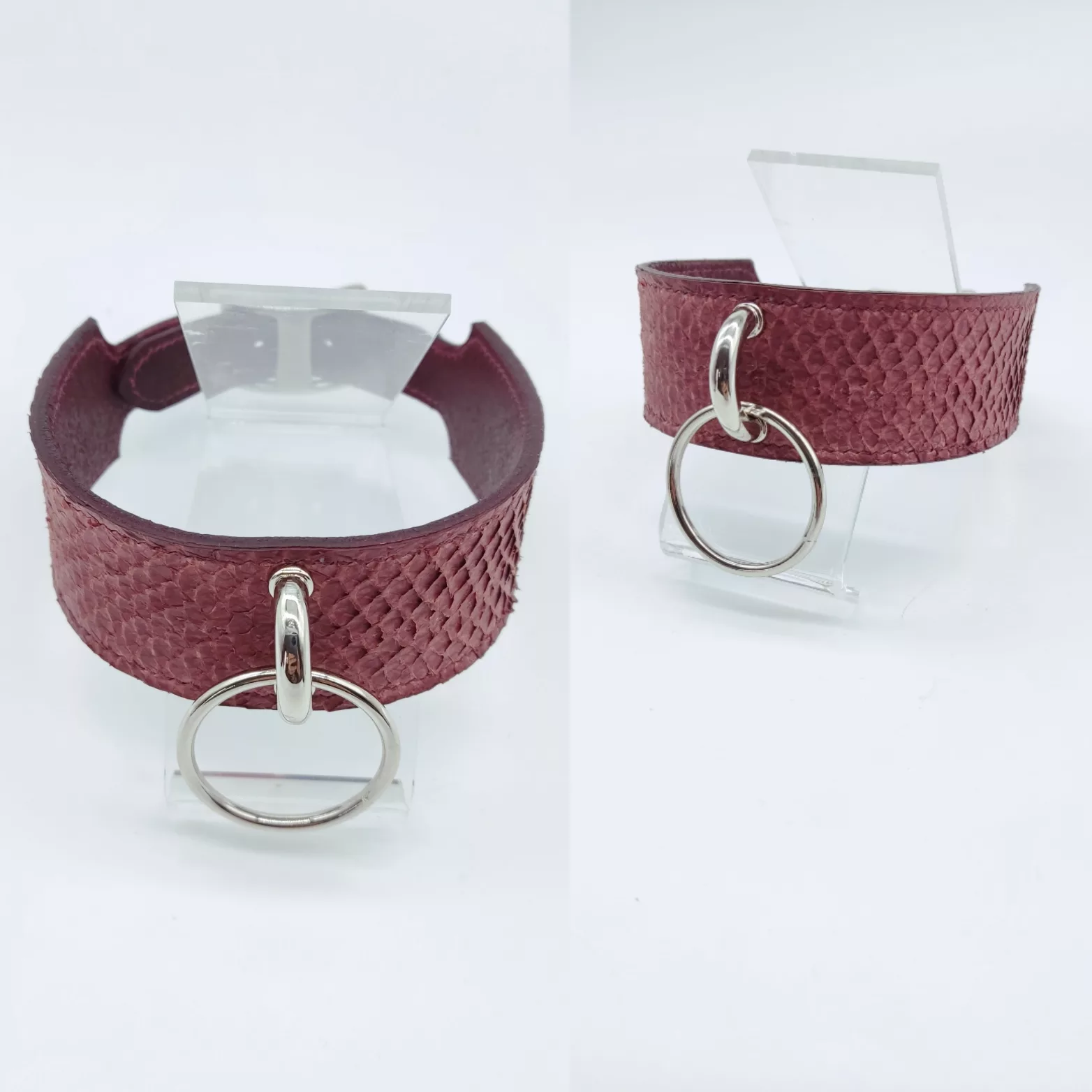 Burgundy leather bracelet with large metal ring, shown from two angles on a clear display stand (product photo).